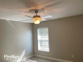 North Port house for rent - a bedroom with a ceiling fan and a window