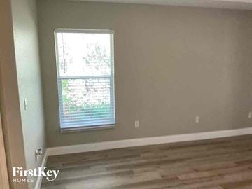 North Port house for rent - a living room with a window and wooden floors