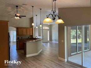 North Port house for rent - an empty kitchen and living room with two lights and a table