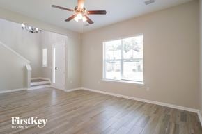 St Augustine house for rent - A room with a ceiling fan and wooden flooring.