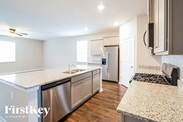 Summerville house for rent - A kitchen with granite countertops and stainless steel appliances.