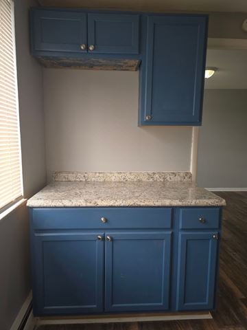Bethel apartment for rent - A kitchen with blue cabinets and a granite countertop.