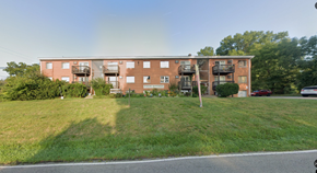 Bethel apartment for rent - A red brick apartment building with a green lawn in front.