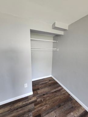 Bethel apartment for rent - A room with a white wall and a wooden floor.