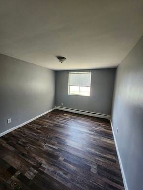 Bethel apartment for rent - A room with a window and wooden flooring.