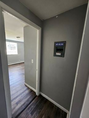 Bethel apartment for rent - A hallway with a door and a control box on the wall.