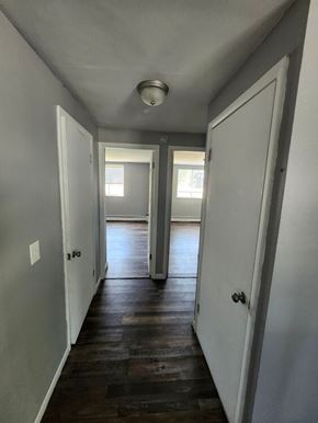 Bethel apartment for rent - A long hallway with white walls and wood floors.