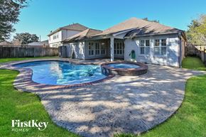 Cypress house for rent - a backyard with a pool and a house