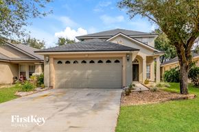 Orange Park house for rent - a beige house with a gray garage door