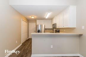 Orange Park house for rent - a kitchen with white cabinets and a counter top