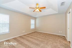 Orange Park house for rent - the master bedroom has a ceiling fan and beige carpet