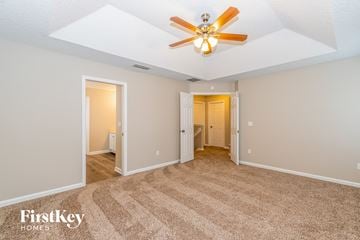 Orange Park house for rent - a living room with a ceiling fan and a carpet