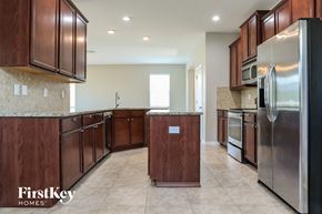 Ruskin house for rent - a kitchen with wooden cabinets and stainless steel appliances