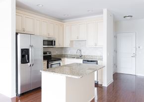 Garfield apartment for rent - a kitchen with white cabinets and a marble counter top