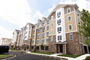 Garfield apartment for rent - a large apartment building with a street in front of it