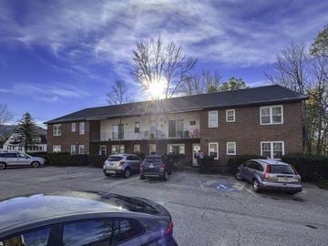 North Conway apartment for rent - a building with cars parked in front of it