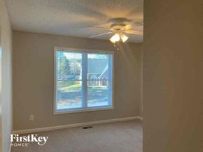 Powder Springs house for rent - an empty bedroom with a ceiling fan and a window