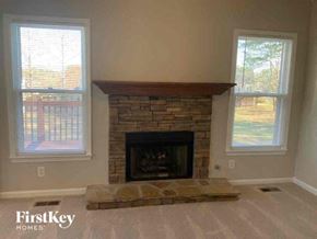 Powder Springs house for rent - a living room with a fireplace and two windows