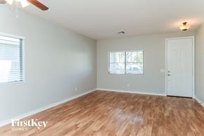 Queen Creek house for rent - the living room of a home with wood floors and a white door