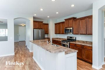 Queen Creek house for rent - a kitchen with wooden cabinets and granite counter tops