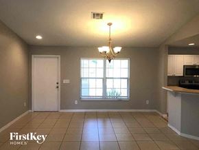 Lehigh Acres house for rent - an empty kitchen and dining room with a large window