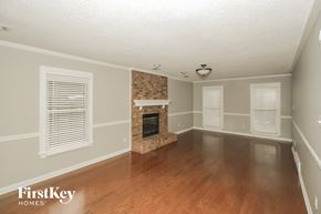 Collierville house for rent - the living room of a house with a fireplace and wooden floors