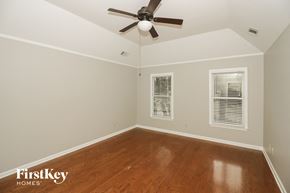Collierville house for rent - a bedroom with wood floors and a ceiling fan