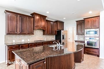 Cypress house for rent - a kitchen with wood cabinets and granite counter tops