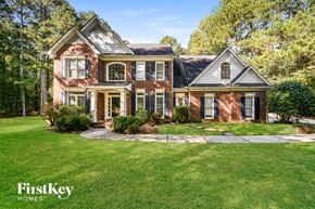 Jonesboro house for rent - a red brick house with black shutters and a green lawn