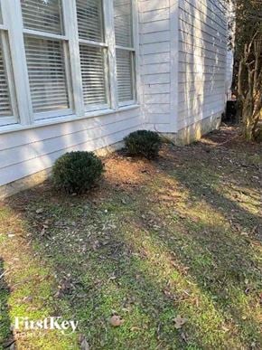 Jonesboro house for rent - the side of a white house with grass and bushes