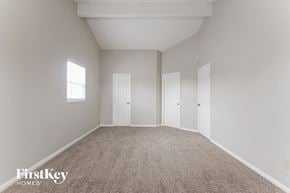 Indianapolis house for rent - a bedroom with carpet and two doors and a window