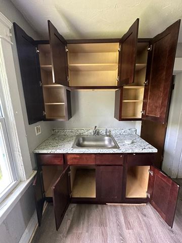 Cleveland apartment for rent - an empty kitchen with a sink and cabinets