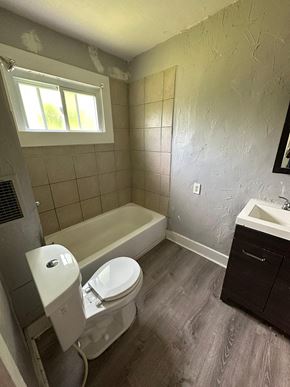 Cleveland apartment for rent - a bathroom with a toilet and a tub and a sink