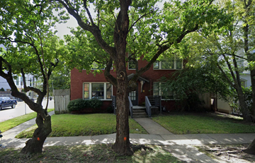 Houston apartment for rent - a red brick house with trees in front of it