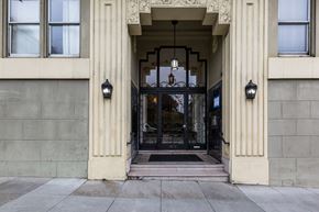 San Francisco apartment for rent - A building entrance with a black gate and a hanging light.