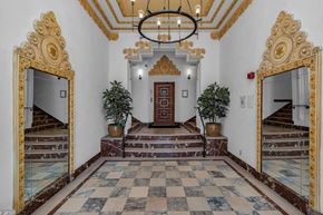 San Francisco apartment for rent - A hallway with a checkered floor and a chandelier.