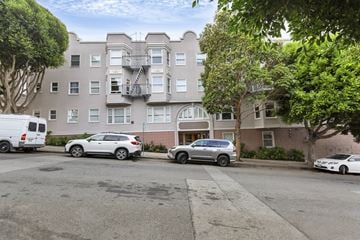San Francisco apartment for rent - A parking lot with cars and a building in the background.