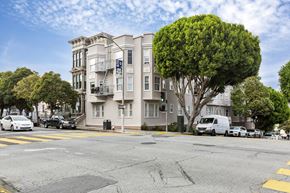 San Francisco apartment for rent - A street view of a residential area with cars parked on the side of the road.