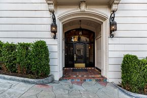 San Francisco apartment for rent - A white building with a black door and two hanging lights.