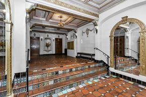 San Francisco apartment for rent - A staircase with a tiled floor and a mirror on the wall.