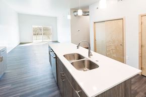 South Sioux City apartment for rent - an empty kitchen with a stainless steel sink and white counter top
