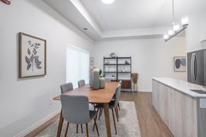 St. Thomas apartment for rent - a dining area with a wooden table and chairs and a kitchen with a refrigerator