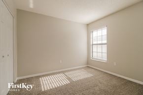Deltona house for rent - a bedroom with a window and a carpeted floor