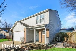 Noblesville house for rent - A house with a grey roof and a brick pillar in front of the door.