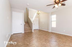 Avondale house for rent - A spacious room with a staircase leading to the second floor.