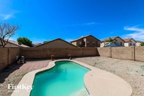 Avondale house for rent - A swimming pool in a backyard with a concrete floor and a concrete wall.