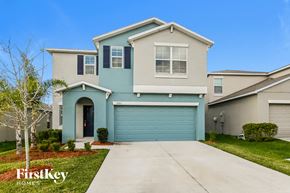Wimauma house for rent - a blue and white house with a blue garage door