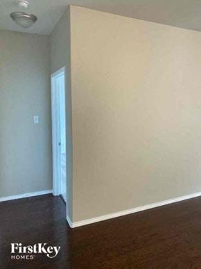 Forney house for rent - A room with a white wall and a wooden floor.
