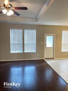 Forney house for rent - A room with a ceiling fan and a door.