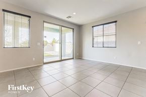 Queen Creek house for rent - an empty living room with sliding glass doors to a patio
